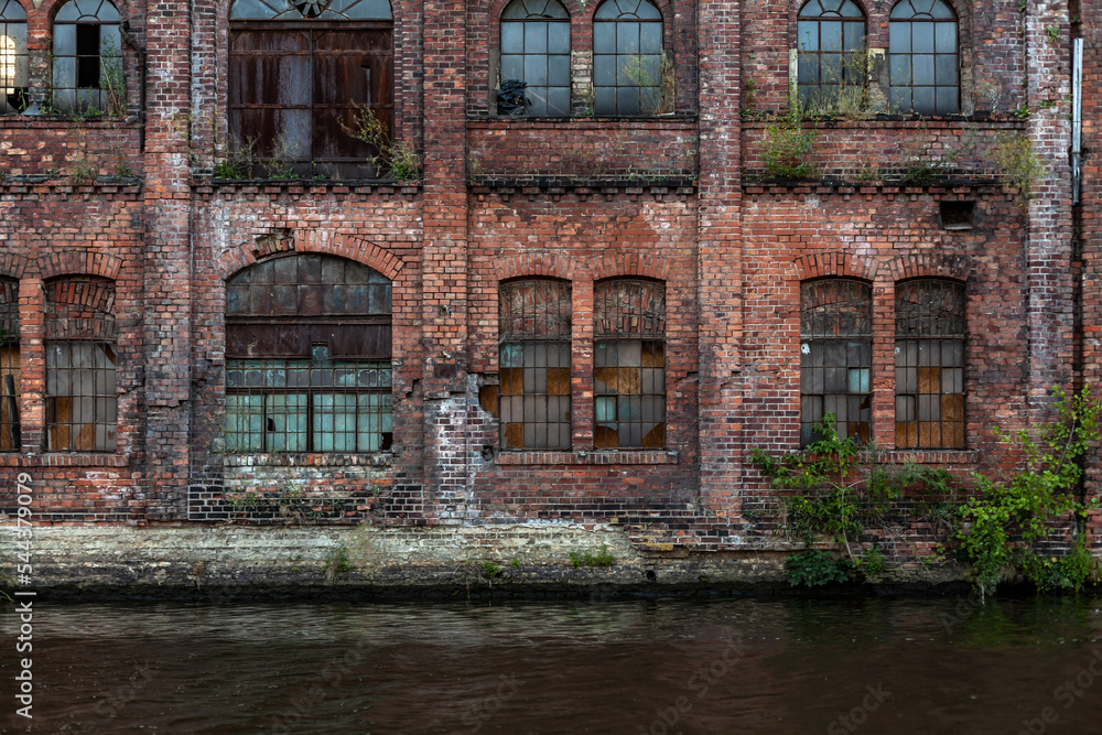 Old grunge factory wall built of red bricks