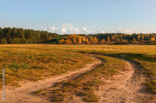 Jesienny krajobraz przy polnej drodze, w słoneczny barwny  dniu przed zachodem słońca.  photo