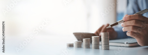 Canvastavla A businessman is keeping a record of his income and expenses, he plans his finances by using his monthly savings to buy funds to make it grow faster