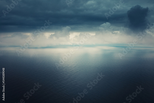 Heavy leaden sky over a calm sea surface - storm and thunderstorm forecast