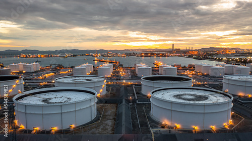 Aerial view oil and gas storage tank farm, Tank farm storage petrochemical petroleum chemical refinery product at oil terminal, Business commercial trade fuel and energy transport tanker ship vessel.