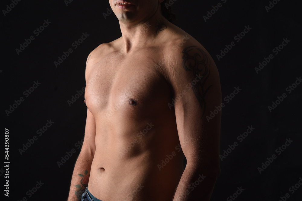 close up of a body shirtless on black background