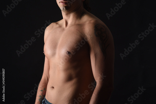 close up of a body shirtless on black background