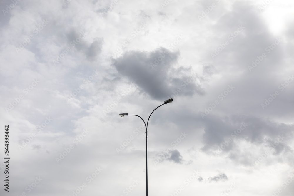 Light pole against sky. Celestial landscape in cloudy weather.