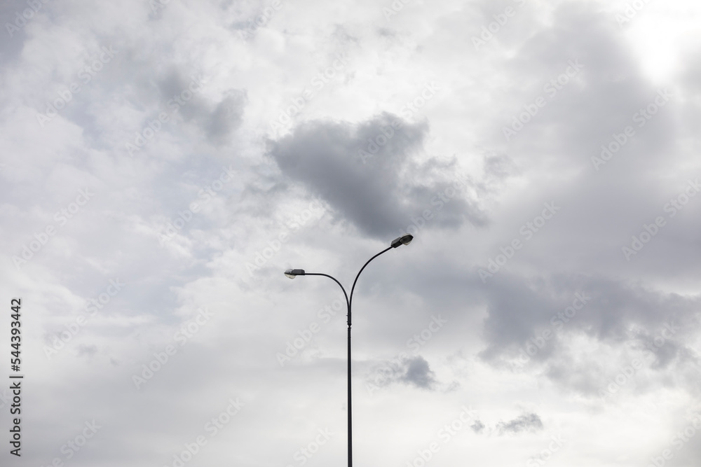 Light pole against sky. Celestial landscape in cloudy weather. Light pole against sky. Celestial landscape in cloudy weather.