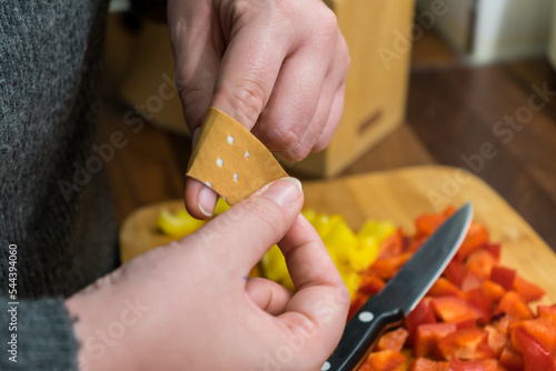 A woman cuts her finger and puts a plaster on it