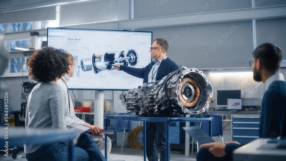 Group of Young Scientists Working: Inspecting Engine in Factory Meeting Room. People Brainstorming with Chief Engineer. Confident Industrial Specialists in Technological Facility. - obrazy, fototapety, plakaty 