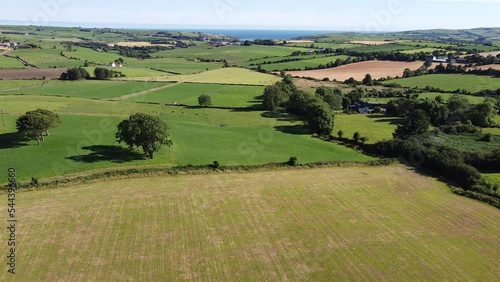 Green fields, view. Agricultural landscape on a summer day, drone video. The countryside of the Irish south. photo