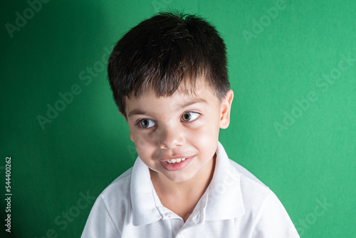Boy in white shirt on the green background