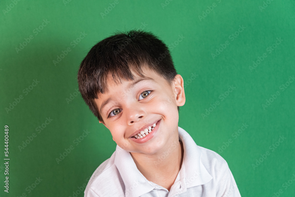 Boy in white shirt on the green background Boy in white shirt on the green background