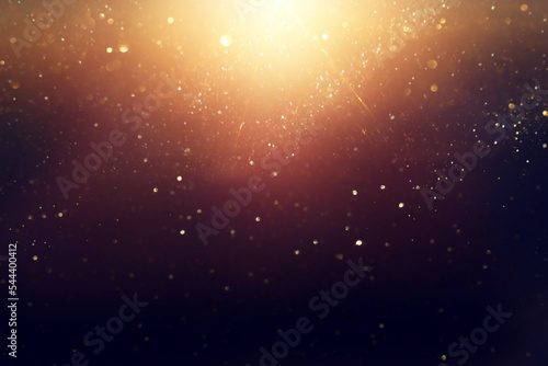 Tableau sur toile background of abstract glitter lights. gold and black. de focused