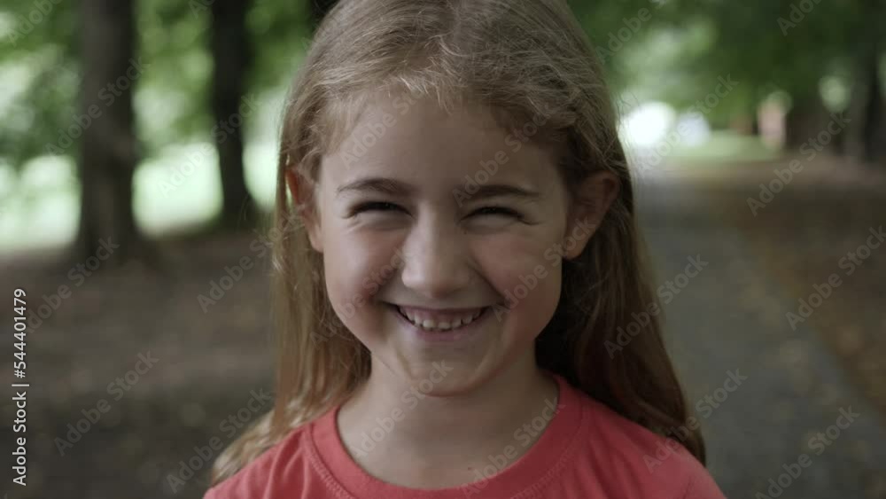 Portrait Smiling Little Girl Looking at Camera. Laughs Happily Child at Outdoors. Inquisitive Little Girl Portrait. Face Funny Contemplative Child. Laughing Cute Pretty Schoolgirl Elementary Student. Portrait Smiling Little Girl Looking at Camera. Laughs Happily Child at Outdoors. Inquisitive Little Girl Portrait. Face Funny Contemplative Child. Laughing Cute Pretty Schoolgirl Elementary Student.