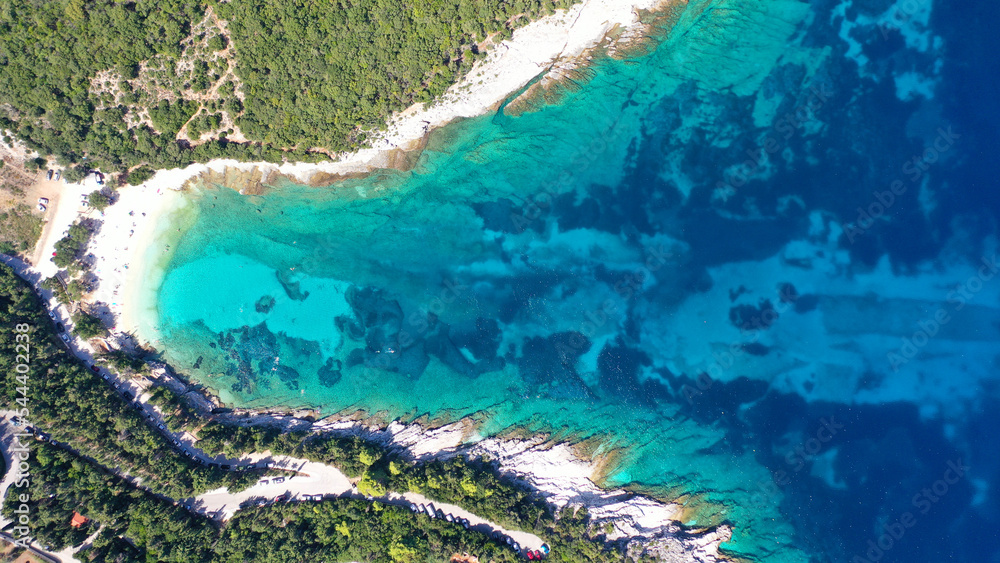 Aerial drone top down photo of tropical exotic paradise secluded rocky bay with deep turquoise sea forming a blue lagoon