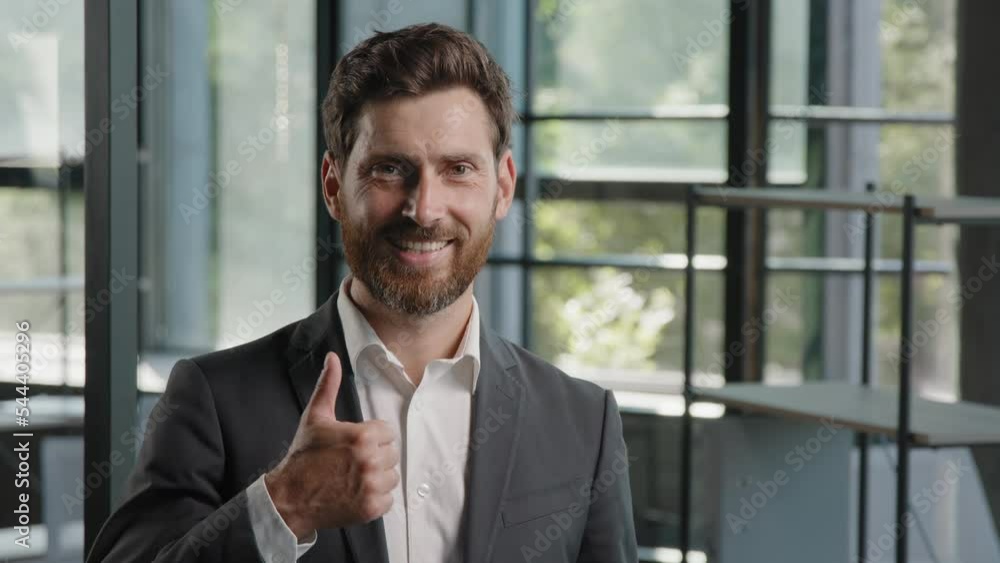 Business portrait in office success confident ambitions middle-aged boss employer showing thumb up gesture adult Caucasian 40s bearded man CEO businessman recommend approve excellent good support sign Business portrait in office success confident ambitions middle-aged boss employer showing thumb up gesture adult Caucasian 40s bearded man CEO businessman recommend approve excellent good support sign