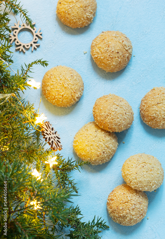 Christmas nut cookies Filbertines on a background of branches, cones and Christmas decorations.