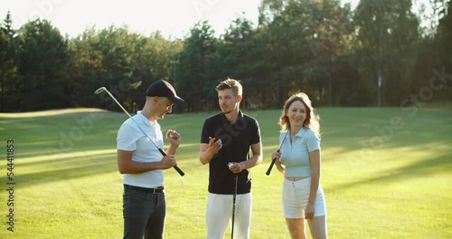 friends on golf court talking, shares his impressions after playing golf. High quality 4k footage