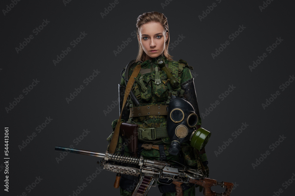 Portrait of survivor woman dressed in camouflage costume with rifle. Portrait of survivor woman dressed in camouflage costume with rifle.