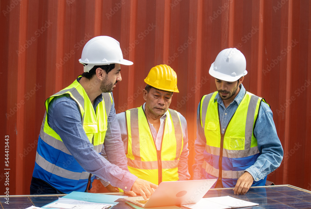 Technician engineers team in safety helmets and uniforms have a conversation about the panel installation, sustainable development concept