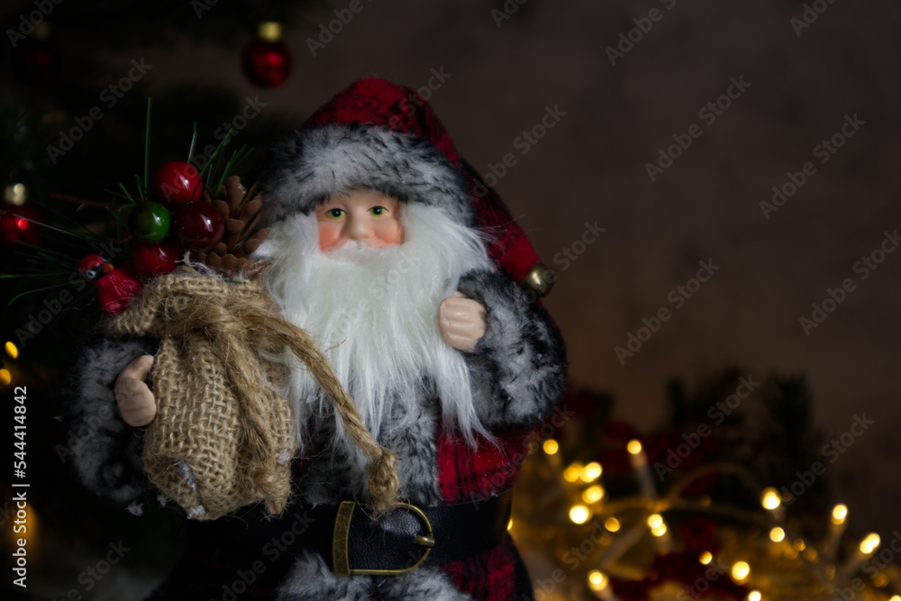 Forest wizard or Santa Claus close-up against the background of a Christmas tree and lights Forest wizard or Santa Claus close-up against the background of a Christmas tree and lights