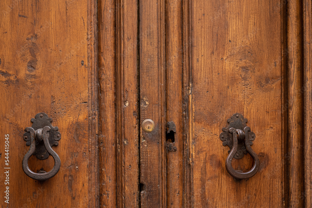 Old wooden door with two handles and lock Old wooden door with two handles and lock