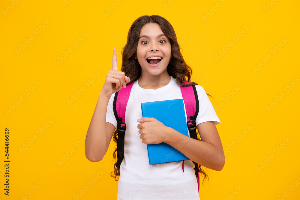 Amazed teen girl. Back to school. Schoolgirl student with school bag backpack hold book on isolated studio background. School and education concept. Teenager girl in school uniform. Amazed teen girl. Back to school. Schoolgirl student with school bag backpack hold book on isolated studio background. School and education concept. Teenager girl in school uniform.