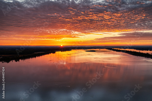 Sunrise over the Tennessee River with beautiful colorful orange sky. Wheeler Wildlife Refuge in Decatur Alabama USA.