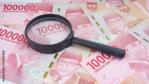 Indonesia rupiah money under a magnifying glass is being inspected Conceptual photo