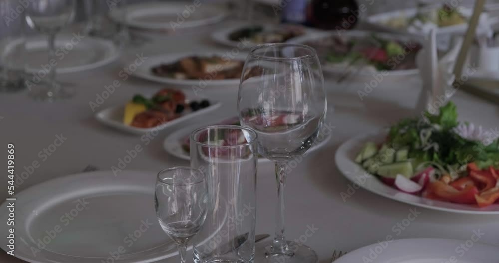 Empty glasses on the festive table. Light disco lanterns Empty glasses on the festive table. Light disco lanterns