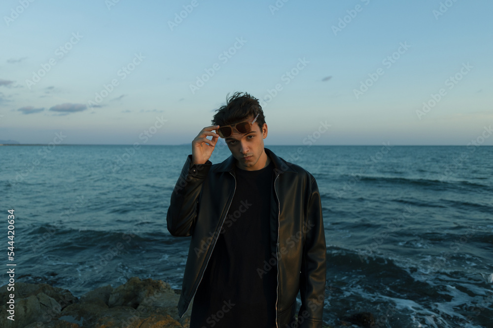 Handsome guy, model, at the sea sensually looks at the camera Handsome guy, model, at the sea sensually looks at the camera