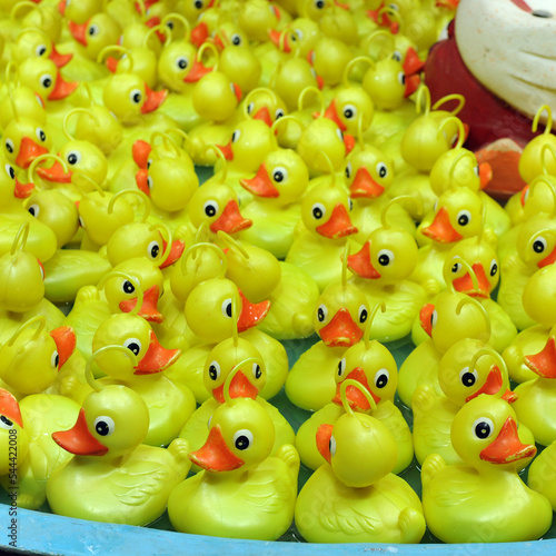 Yellow plastic duck fishing game with prize at a fair, concept of luck and skill photo