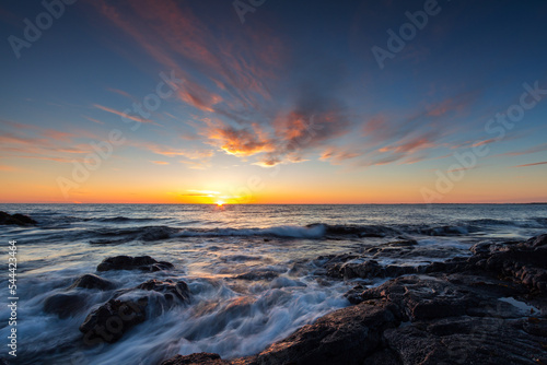 Print op canvas Rocky shore of the Atlantic Ocean at high tide at sunset