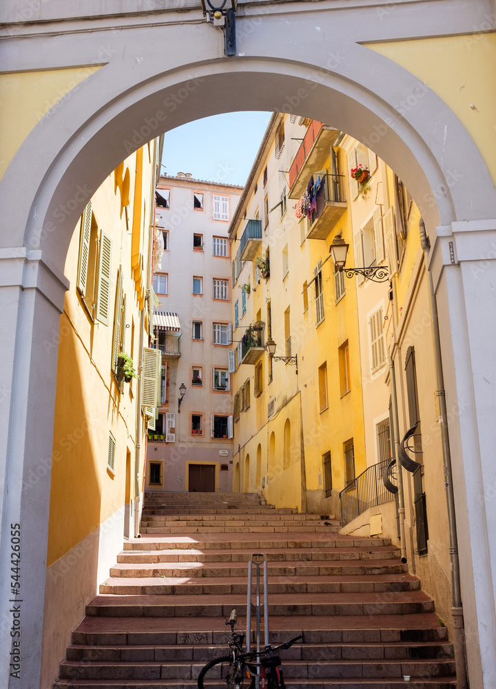Yellow buildings along a scenic street in old Nice, France 