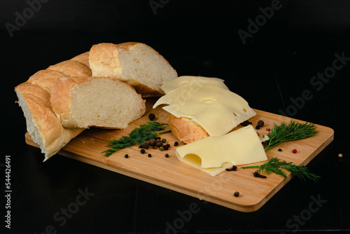 Sandwich with butter and cheese on a wooden board