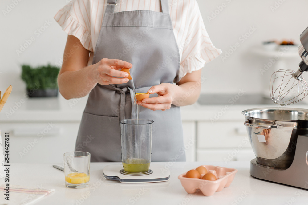 woman confectioner prepares a cake in the kitchen at home. close-up of female hands and ingredients. High quality photo woman confectioner prepares a cake in the kitchen at home. close-up of female hands and ingredients. High quality photo