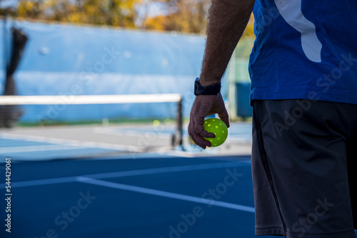 People Playing pickleball outdoors.  