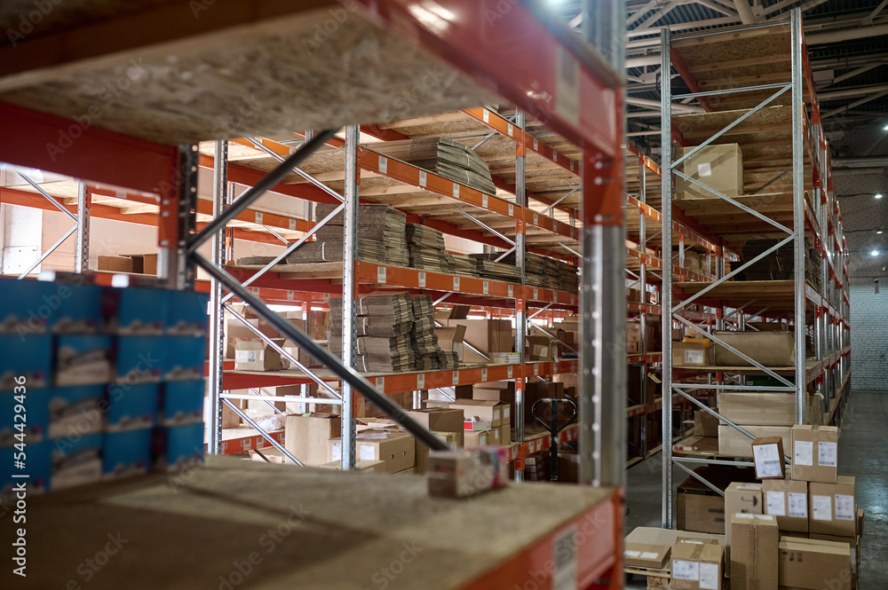 Fototapeta premium Merchandise in cartons stored on the storehouse shelves