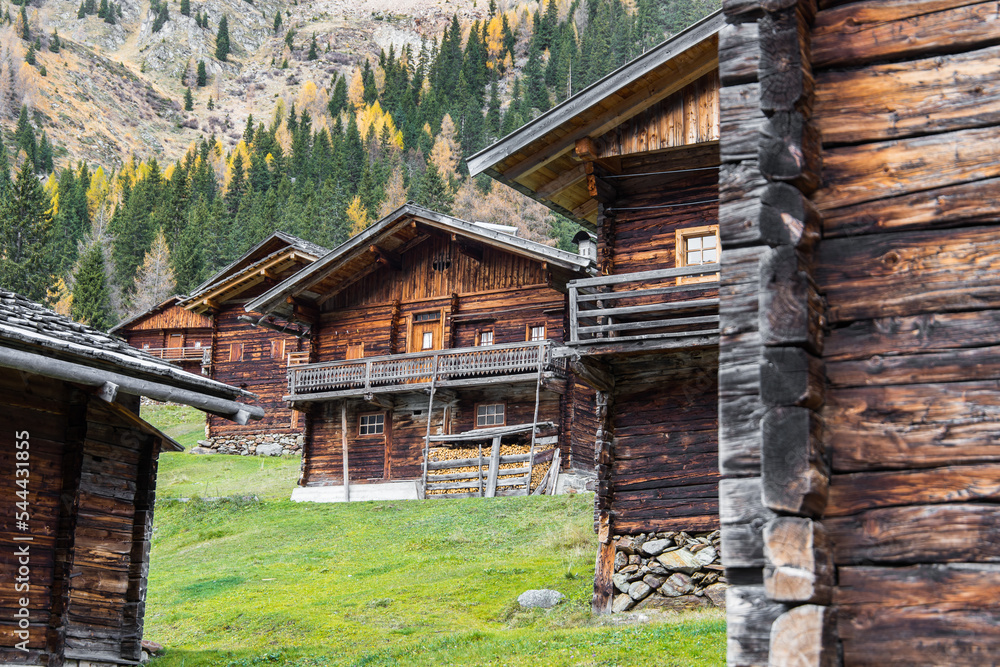 Idyllic group of historic wooden farm houses on a alpine pasture in Austria during autumn Idyllic group of historic wooden farm houses on a alpine pasture in Austria during autumn