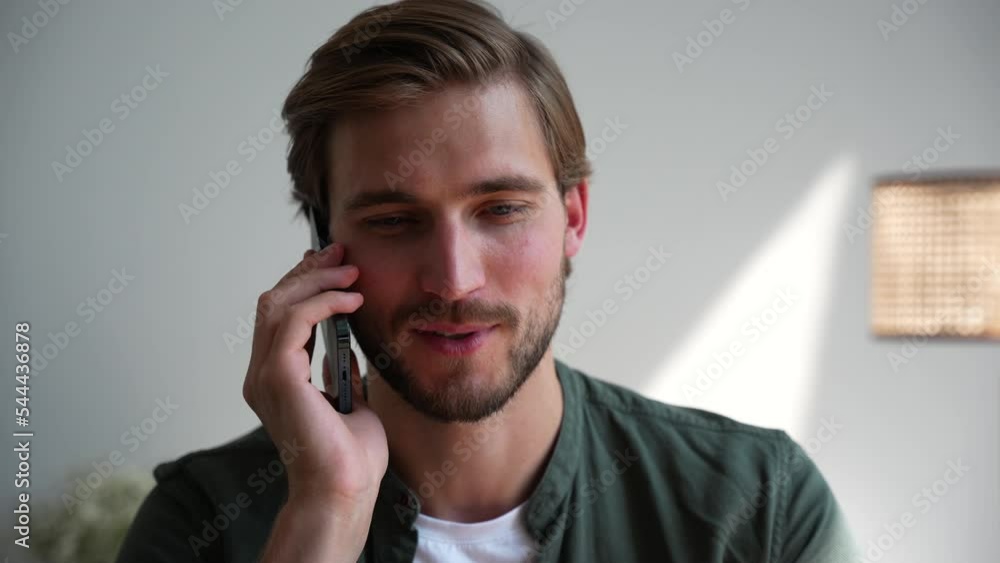 Cheerful businessman talking mobile phone emotionally at home office. Positive entrepreneur supporting client on smartphone Cheerful businessman talking mobile phone emotionally at home office. Positive entrepreneur supporting client on smartphone