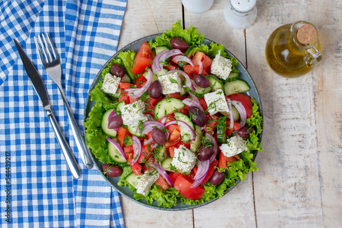 Greek salad with fresh vegetables, feta cheese and olive oil.  Top view