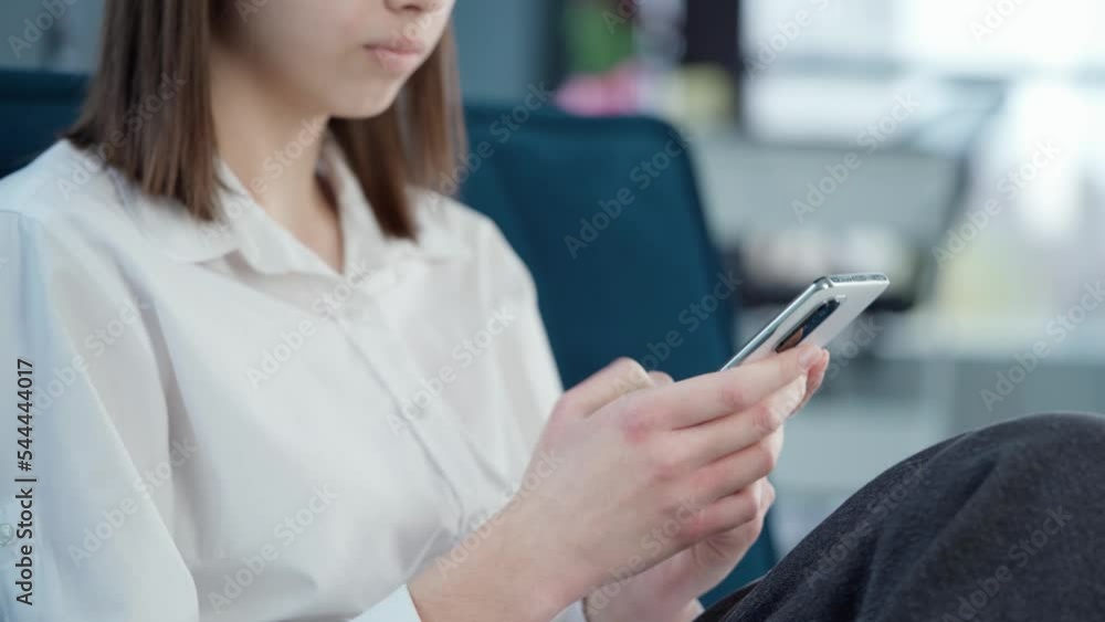 Woman Using Phone Sitting On Sofa In Office Or At Home Woman Using Phone Sitting On Sofa In Office Or At Home