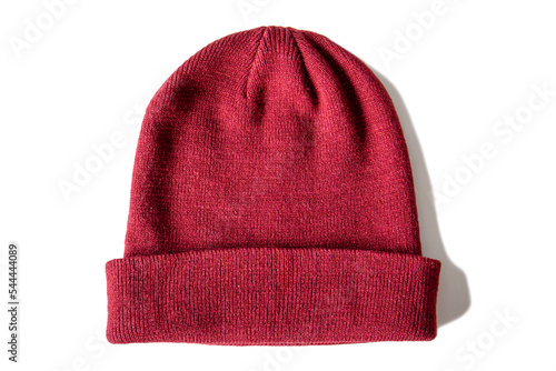 Warm knitted red wool hat on insulated white background, top view