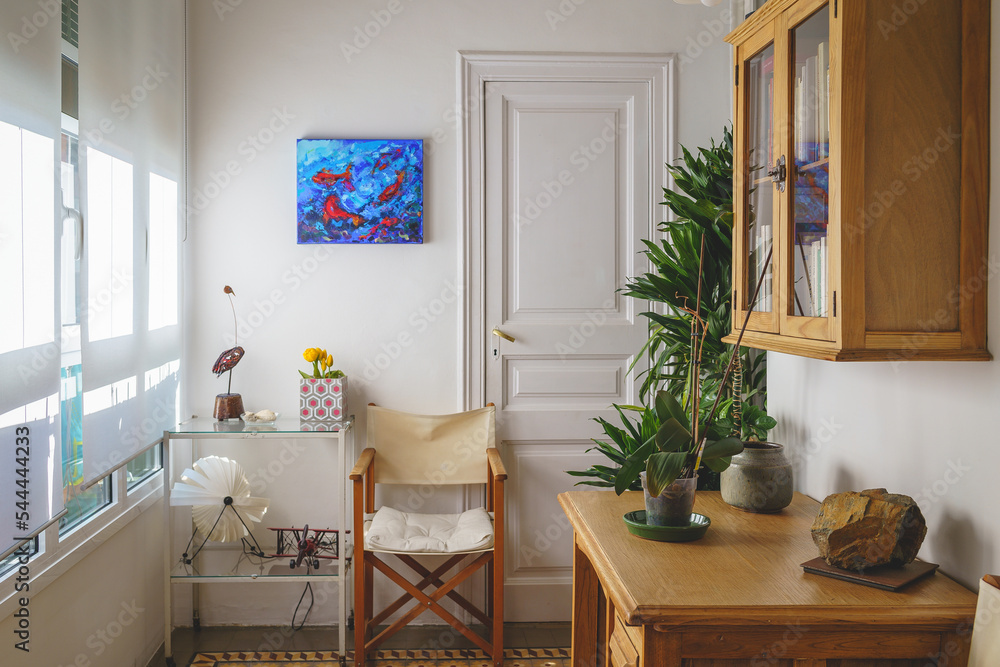 living room interior with stylish armchairs, wooden coffee table, and gallery of posters on white wall living room interior with stylish armchairs, wooden coffee table, and gallery of posters on white wall