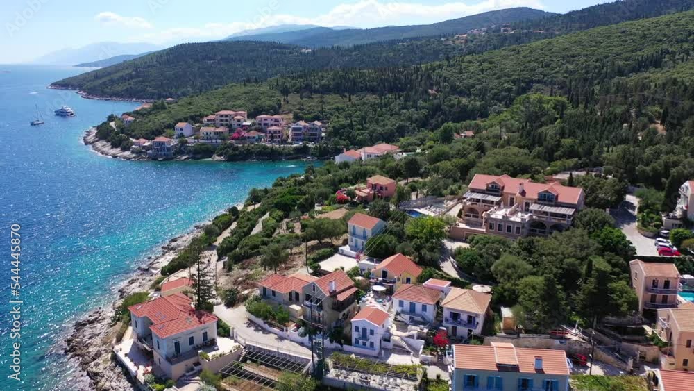Aerial drone video from iconic picturesque fishing village and bay of Fiskardo with beautiful traditional houses of Ionian architecture, Cefalonia island, Greece Aerial drone video from iconic picturesque fishing village and bay of Fiskardo with beautiful traditional houses of Ionian architecture, Cefalonia island, Greece