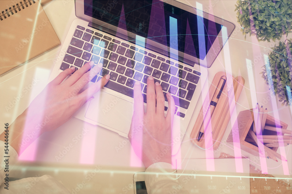 Double exposure of woman hands working on computer and forex chart hologram drawing. Top View. Financial analysis concept. Double exposure of woman hands working on computer and forex chart hologram drawing. Top View. Financial analysis concept.
