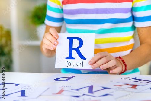 The child learns English letters. Selective focus.