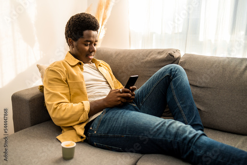 Young African American man using mobile phone. photo