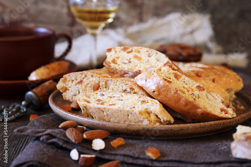 Italian cookies: almond and candied orange cantuccini (biscotti), coffee and glass of white wine photo