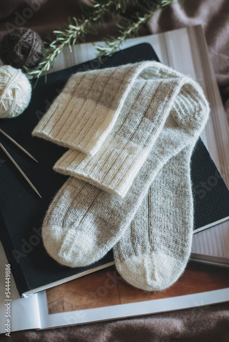 Hand knitted socks with needles and yarn ball. Concept for handmade and hygge slow life.