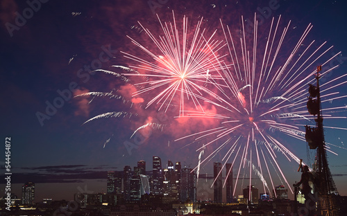 Fireworks over the monument to Peter the Great and Moscow City skyscrapers on a summer evening.