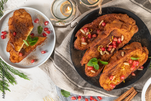 Bilde på lerret Traditional Christmas Rabanadas with lemon zest, pomegranate, pine nuts and cinnamon